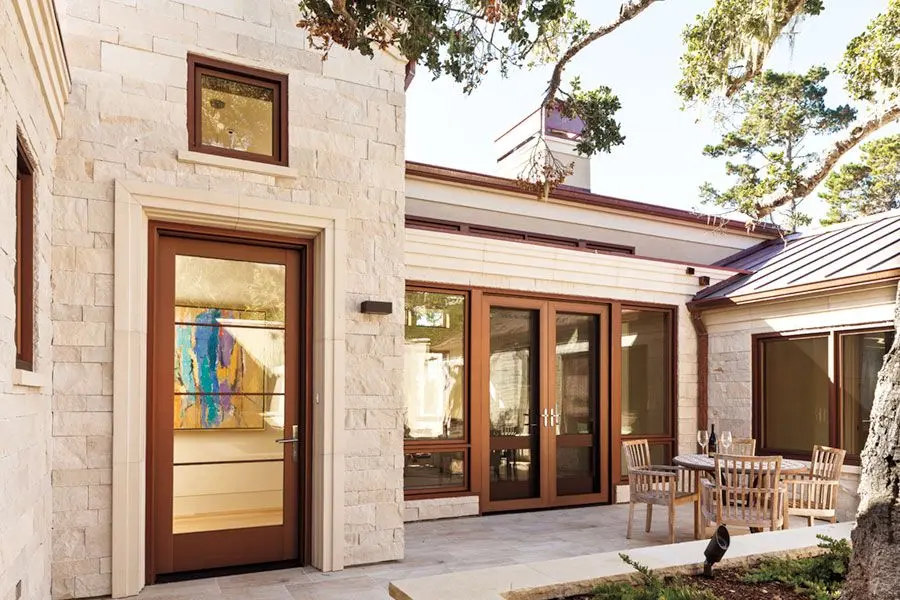 412397_pinn_copperanodizedext_a_p_pd_jensen_pebblebeachca_2014_6_cc_f3wsvo26hquihs5atihbbg-900x600 (1) Exterior view of a modern home with light stone walls