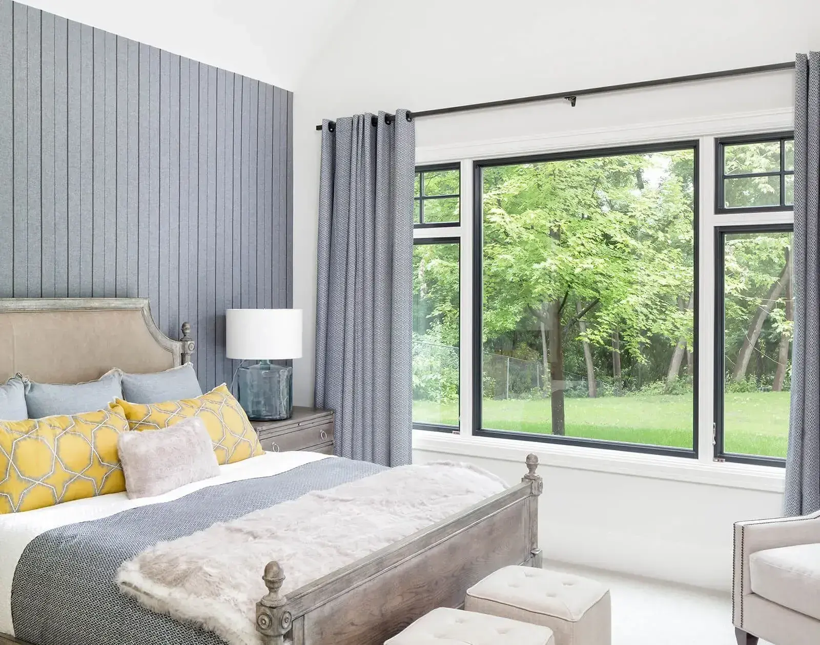 Bright bedroom with large black-framed window